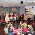 Children interacting with Betty and her balloon story of the three little pigs